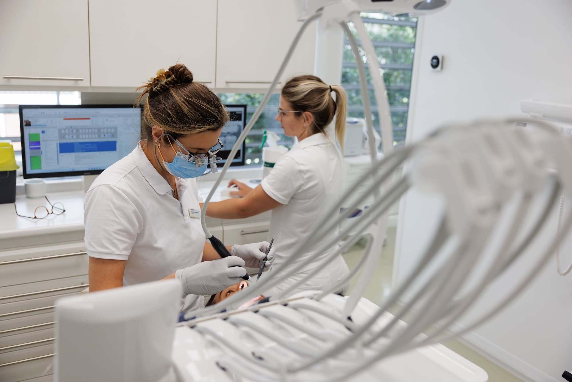 Een tandarts behandelt een patiënt met hulp van een tandartsassistent in de TandZuiver-kliniek in Heemstede.